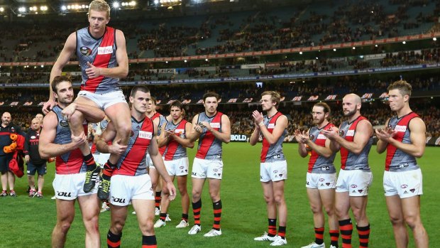 Dustin Fletcher of the Bombers is chaired off the ground after his 400th game.