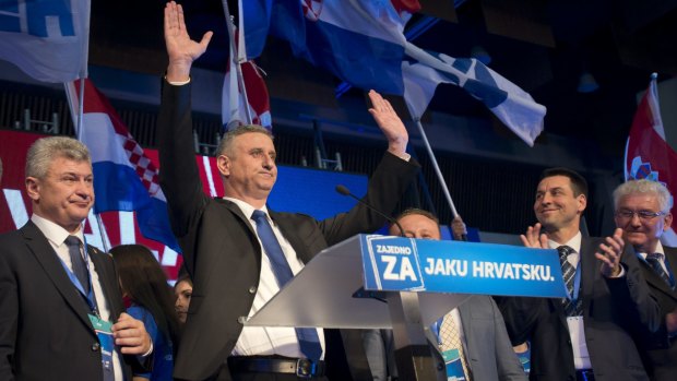 Opposition leader Tomislav Karamarko, second from left, celebrates his coalition's win.