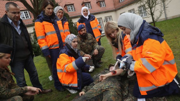 BERLIN, GERMANY - NOVEMBER 17: Syrian refugees demonstrate skills they have learned in a first aid training program sponsored by the Bundeswehr for Syrian female refugees during a media event at the Julius Leber barracks on November 17, 2016 in Berlin, Germany. The Bundeswehr has launched a series of job-training programs for refugees in an effort to help integration efforts in conjunction with Germany's Work Agency (Agentur fuer Arbeit). Germany took in approximately one million refugees and migrants since last year. (Photo by Sean Gallup/Getty Images)