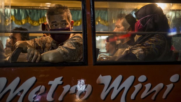 Bus passengers in Jakarta where smog from vehicles is getting worse. 