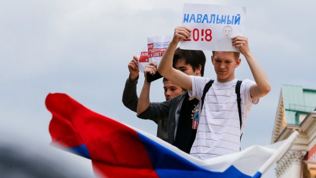 A young protester holds up a pro-Alexei Navalny banner during a demonstration in downtown Moscow.
