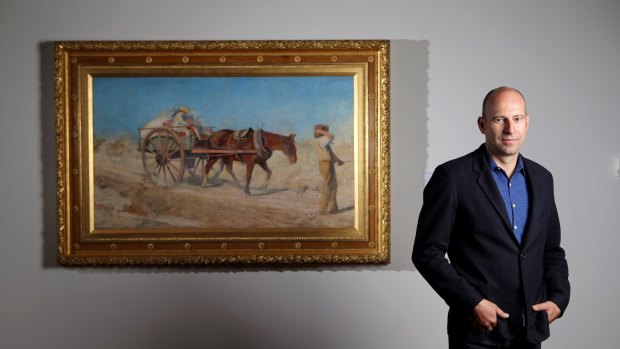 NGV head of conservation Michael Varcoe-Cocks with the restored McCubbin work, The North Wind.