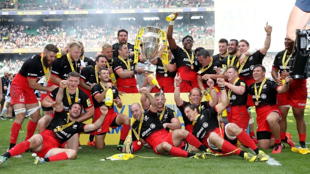Sweet success: Saracens players celebrate with the trophy after the Premiership final against Exeter Chiefs at Twickenham Stadium.