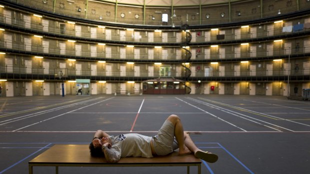 Iranian migrant Reda Ehsan, 25, lies on a table at the former prison of De Koepel in Haarlem.