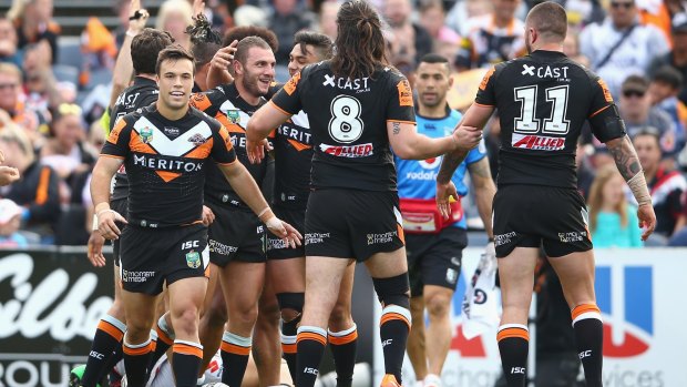 Source of contention: Robbie Farah celebrates with after scoring a try during the Wests Tigers match against the Warriors.