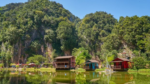 Wooden houses on Ipoh Lake, Malaysia. The limestone outcrops just outside town are reminiscent of Halong Bay in Vietnam.