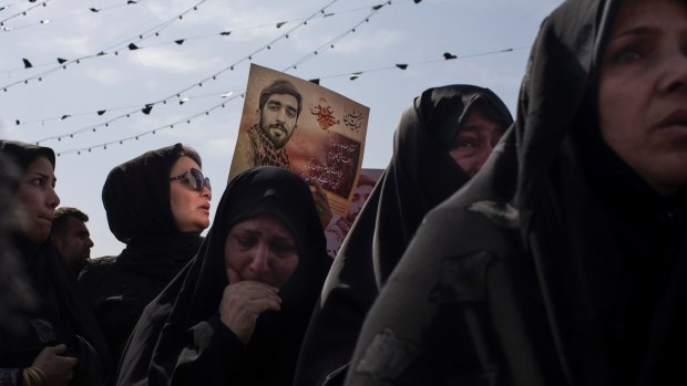 Women mourn at the funeral for Mohsen Hojaji, an obscure 26-year-old who was killed fighting in Syria.