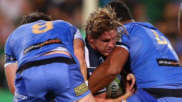 Hard runner: Michael Hooper gets tackled by Ben McCalman and Sitiveni Mafi during the round nine Super Rugby match between the Force and the Waratahs at nib Stadium.