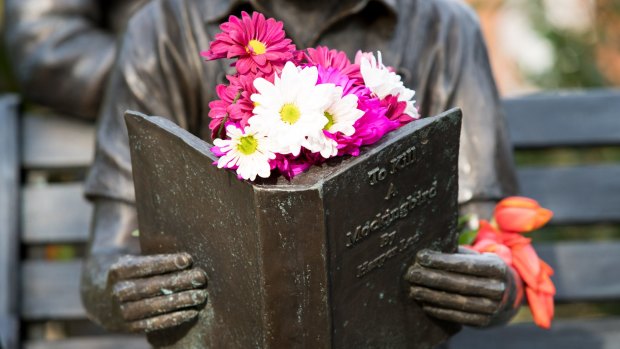 Flowers left on a sculpture in tribute to Harper Lee and her famous novel.