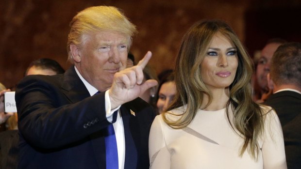 Donald Trump waves as he stands with his wife Melania  before giving his victory speech.