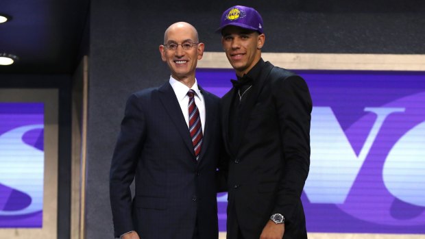 Lonzo Ball walks on stage with NBA commissioner Adam Silver.
