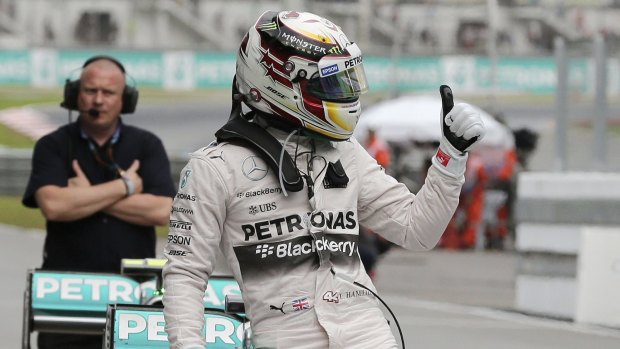 Mercedes driver Lewis Hamilton of Britain gives a thumbs-up after taking pole position for Sunday's Malaysian Grand Prix.
