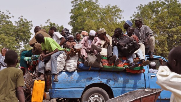 Exodus: Villagers flee violence near the city of  Maiduguri in north-eastern Nigeria. 
