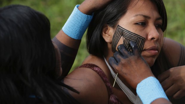 A Kayapo paints the face of her daughter during an assembly in Brasilia on Monday. Indigenous ethnic groups are in the capital to demand education, health and demarcation of indigenous lands. 