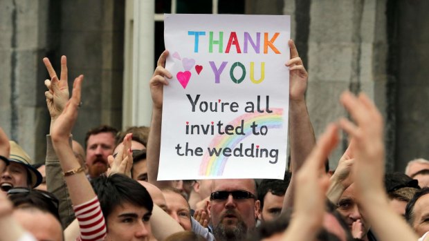 A supporter holds up a sign as he celebrates outside Dublin Castle, Ireland.