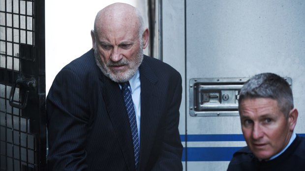 Ian Macdonald is led into the Supreme Court on Friday to be sentenced. 