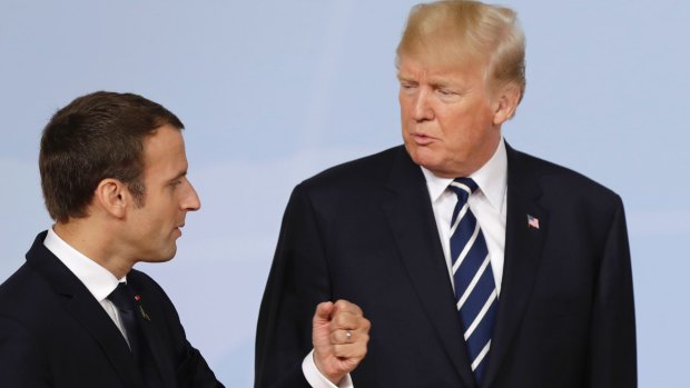 French President Emmanuel Macron talks with US President Donald Trump after the family photo on the first day of the G-20 summit in Hamburg.
