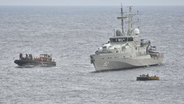 A Royal Australian Navy ship takes part in an effort to rescue suspected asylum seekers off Christmas Island in June 2012.