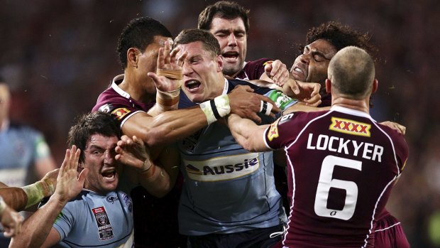 Bad memories: Luke O'Donnell is caught in the middle after Maroons players reacted to a spear tackle on Darius Boyd at Suncorp Stadium 2010.