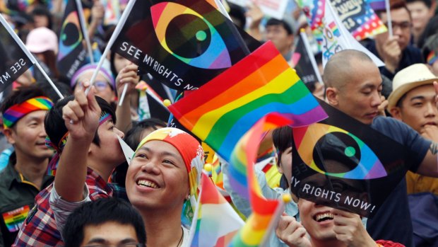 Supporters of LGBT and human rights wave rainbow flags during a rally supporting a proposal to allow same-sex marriage in Taipei in early December.