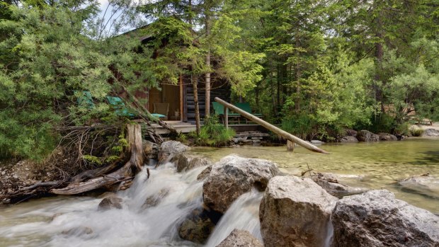 The hotel's sauna is a wooden hut precariously perched on boulders by the river's edge.