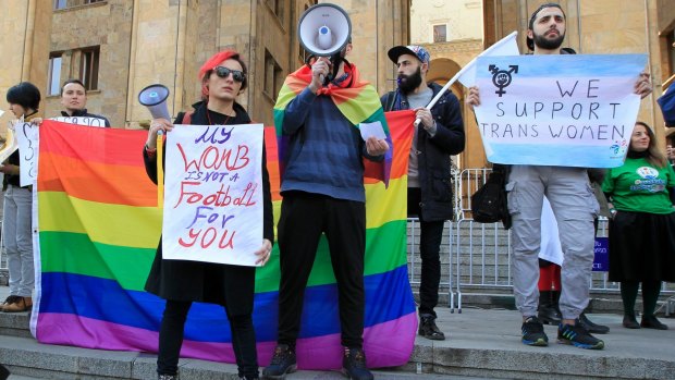 People hold posters in support of gay rights during a rally to mark International Women's Day in Tbilisi, Georgia.