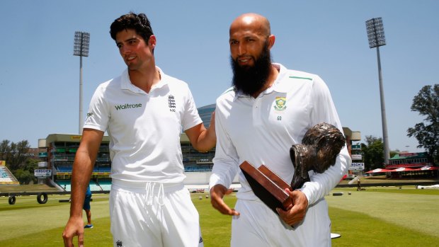 Cook and South Africa captain Hashim Amla after posing for photographs with the Basil D'Oliveira trophy at Kingsmead on Thursday.