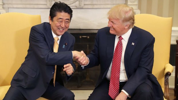 US President Donald Trump shakes hands with Japan's Prime Minister Shinzo Abe in the Oval Office of the White House. 
