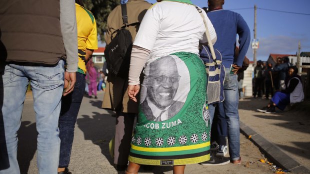 The ANC's standing has been hit by corruption scandals involving President Jacob Zuma, seen here on a voter's dress, but it is unlikely he will be removed from office.