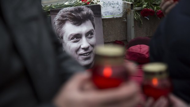 Mourners lay flowers and candles at the spot where Boris Nemtsov was gunned down.