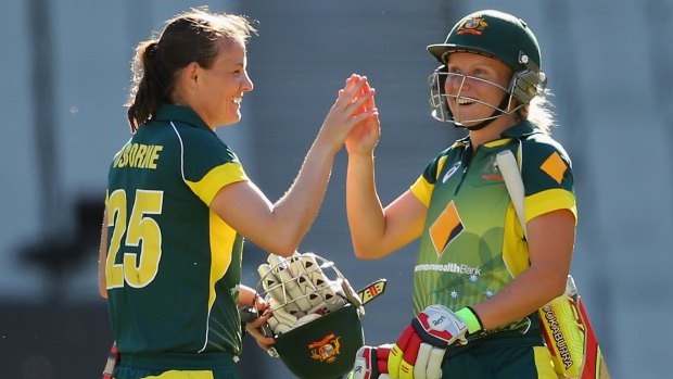 That was close: Erin Osborne and Alyssa Healy celebrate Australia’s win. 