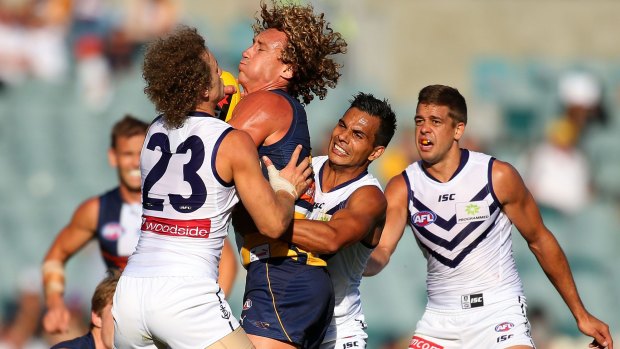 Matt Priddis of the Eagles is tackled by Chris Mayne and Danyle Pearce of the Dockers when the teams met in the NAB Challenge earlier this year.