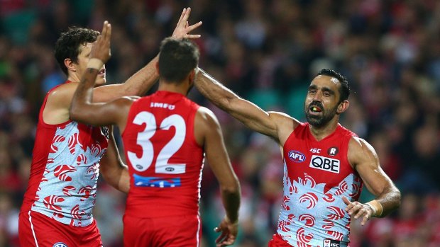 Over she goes: Adam Goodes of the Swans celebrates kicking a goal.