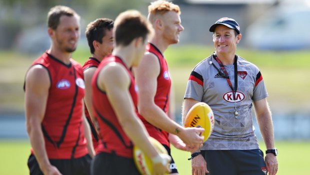 People person: Essendon coach John Worsfold talks to his players during a training session ahead of the Anzac clash with Collingwood. 