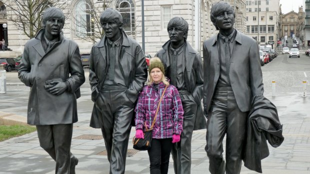 A fan gets a photo with 'The Beatles' in Liverpool.