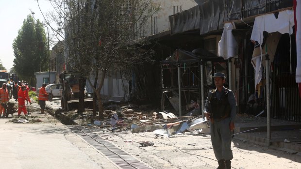 Municipality workers clean up at the site of Monday's suicide attack in Kabul.