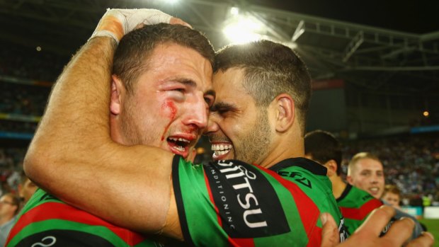 Back together: Sam Burgess and Greg Inglis celebrate winning the 2014 NRL grand final. Burgess has returned to Redfern after a season in rugby.