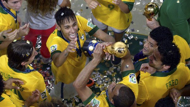 Brazil's Neymar celebrates with his teammates after winning the 2013 FIFA Confederations Cup final between Brazil and Spain at the Maracana stadium in Rio de Janeiro.