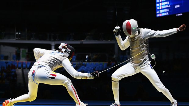Enzo Lefort, right, takes on Germany's Peter Joppich in the men's foil.