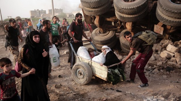 Civilians flee heavy fighting between Islamic State militants and Iraqi special forces in western Mosul. 