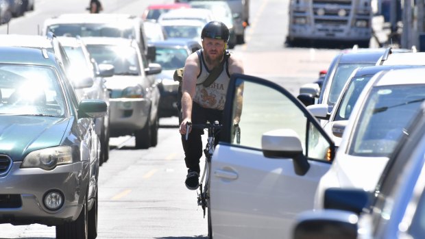 A cyclist makes his way along Sydney Road in Brunswick. 