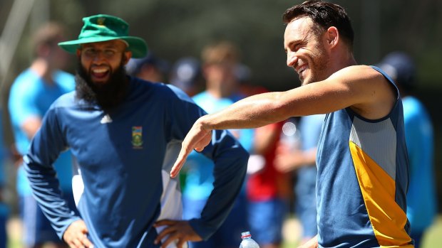 Hashim Amla and Faf du Plessis share a joke during a nets session at Manuka Oval on Monday.