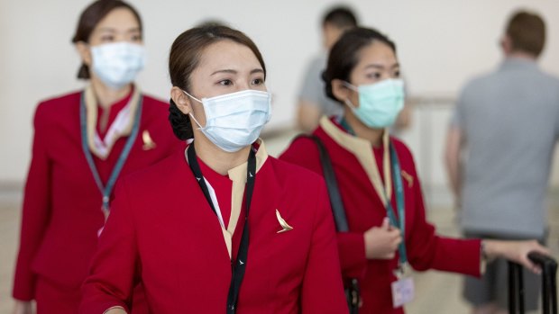 Cathay Pacific flight attendants wearing face masks at Brisbane Airport.