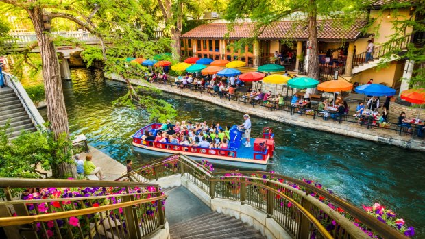 People dine at restaurants along The Riverwalk, a scenic canal of the San Antonio River, in downtown San Antonio, Texas.