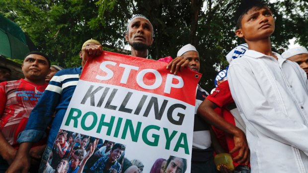 A Rohingya holds a banner during protest after Friday prayers outside the Myanmar embassy in Kuala Lumpur, Malaysia,  in November.