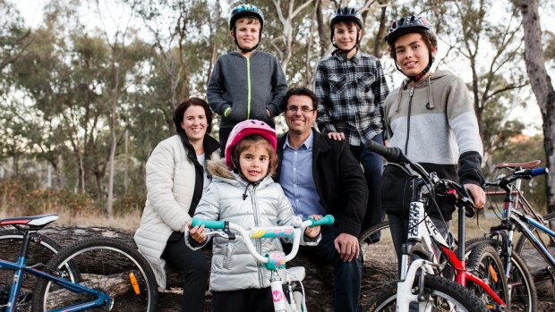 The government will announce funding for more cycle paths in next week's ACT budget. Kate and Liam Osborne with their kids, (front) Olivia 5, and Patrick 12, (back) Liam 8, and Ryan 10.