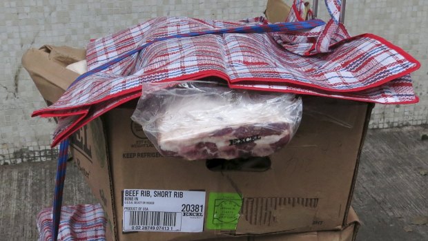 Ribs from the United States are left behind by a smuggler after policemen cordoned off a back alley at an industrial area in Hong Kong.