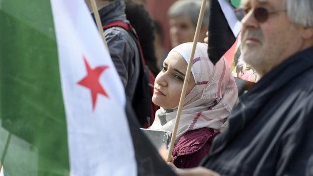 Syrian protesters in Geneva demonstrate against the bombing of Aleppo.
