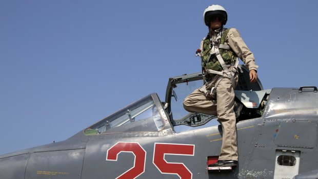 A Russian army pilot poses on the cockpit of a Su-25 jet fighter. Russian airstrikes have proved crucial in turning the tide against Syrian rebels backed by the CIA.