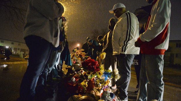 A small group of protestors gather at the memorial for Michael Brown at Canfield Apartments in Ferguson, Missouri in March. 